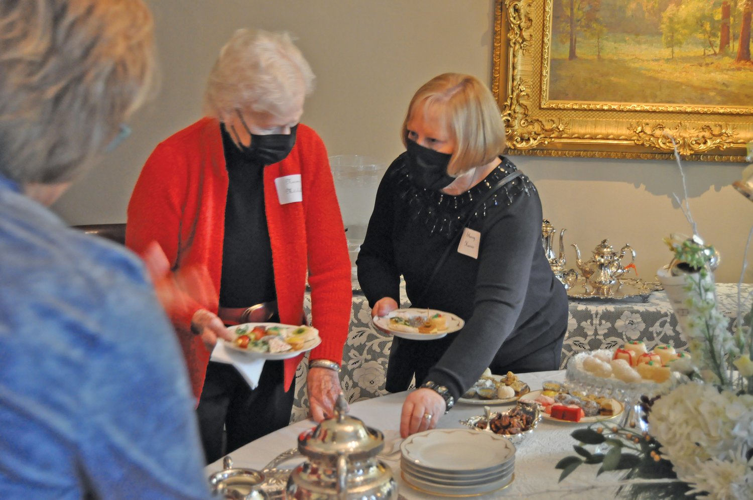 Sherry Harris, right, and her guests leave the refreshment table at the Sounds of the Season Holiday Tea & Fashion Show at the Elston Homestead. The annual event is a fundraiser for the General Lew Wallace Study & Museum.